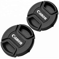 Center clip lens cap with strap holder