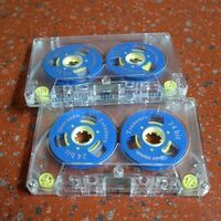 Blank audio cassette tape with two reel cassettes, blue and yellow colors, cassette tape.