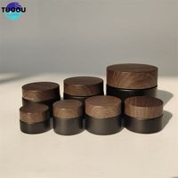 Stock Wholesale 5/10/15/20/30/50G Matte Black Face Cream Jars Containers 1 2 4 oz Glass Jars with Plastic Wood Grain Lids