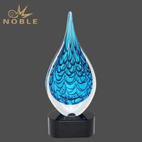 Hand-blown art glass drop trophy on black background